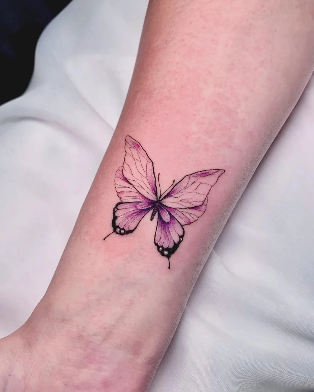 Tattoo: Purple butterfly, forearm